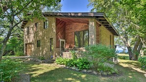 A modern house with a brick exterior, large windows, and a covered porch. - Brocton Escape: Skiing, Snowtubing, Hiking! (Brocton)