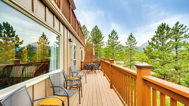 A wooden deck with outdoor furniture, a staircase, and a view of trees and mountains. - Estes Park Condo w/ Deck & Views ~ 3 Miles to Rmnp (Estes Park)