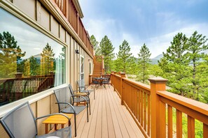 A wooden deck with outdoor furniture, a staircase, and a view of trees and mountains. - Estes Park Condo w/ Deck & Views ~ 3 Miles to Rmnp (Estes Park)