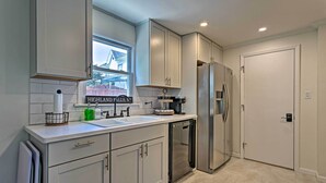 A modern kitchen with white cabinets, a stainless steel refrigerator, and a dishwasher. - Updated Home w/ Patio Half Mile to West Point (Highland Falls)