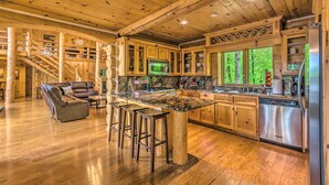A spacious kitchen with wooden cabinets, a granite countertop, and a stainless steel refrigerator. - Private Dock & Slip: Lake Hamilton Hideaway! (Royal)
