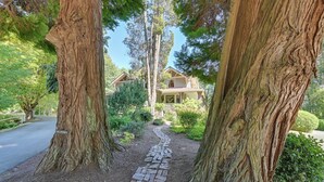 A pathway leading to a house surrounded by large trees. - Historic Auburn House on 37 Acres w/ Private Lake! (Kent)