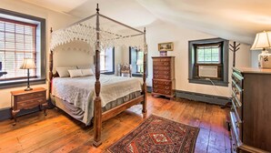 A four-poster bed with a canopy, a dresser, a nightstand, and a window with blinds. - Beautiful Historic House In Amish Country (Ephrata)