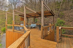 A wooden deck with outdoor seating and a pergola structure. - Serene 'mountain Mist' Retreat w/ Deck & Hot Tub! (Maggie Valley)