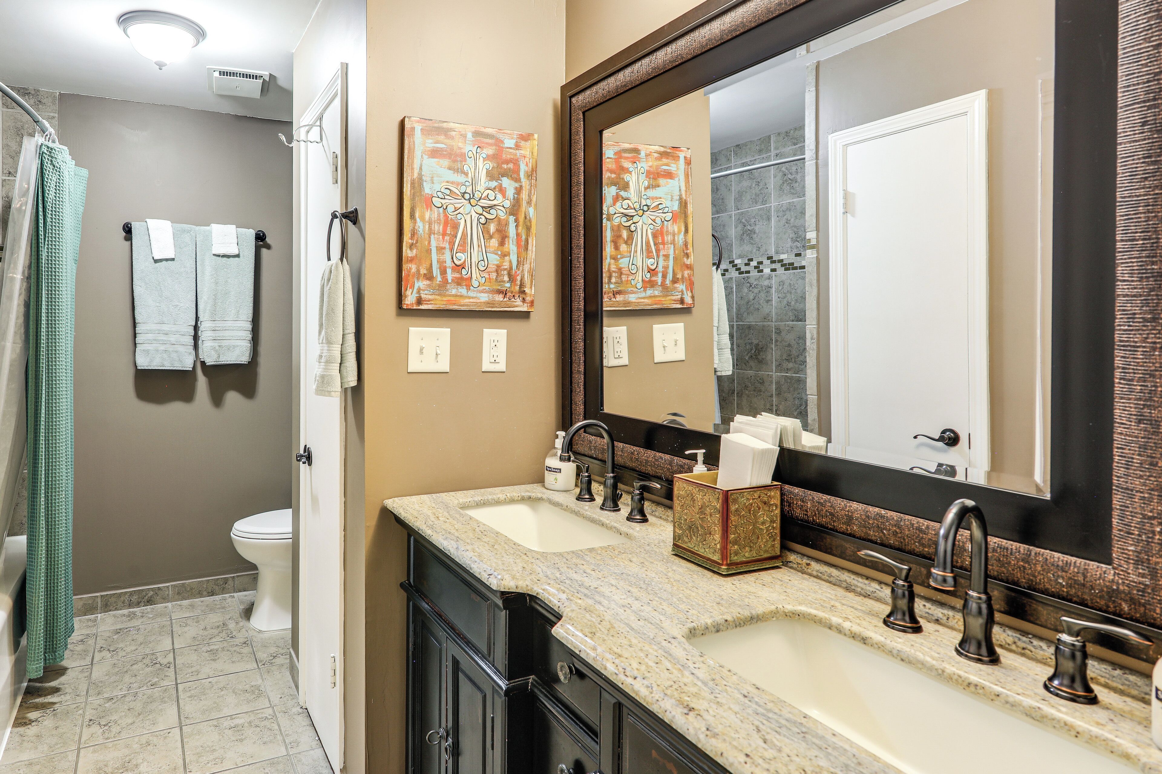 A bathroom with a sink, mirror, towel rack, and toilet.