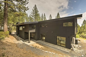 A modern two-story house with large windows and a flat roof, surrounded by trees. - Sleek & Spacious Incline Village Hideaway! (Incline Village)