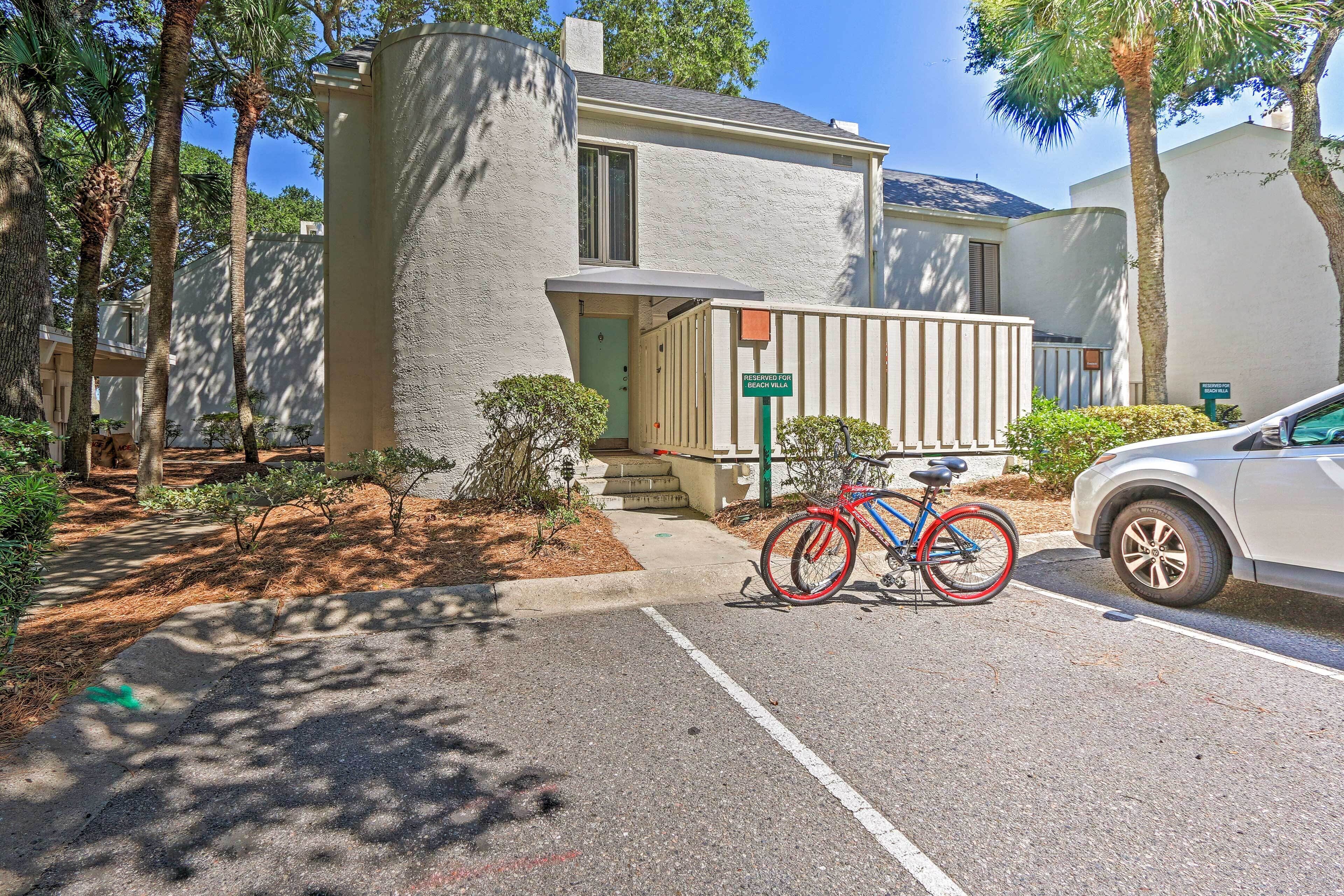 A residential street with a parked bicycle and a car.