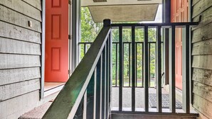A wooden staircase with a metal railing leading to a porch. - Condo w/ Sunroom, Near Downtown Hendersonville! (Hendersonville)
