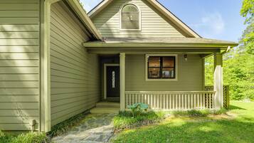 A house with a front porch, a door, and a small window.