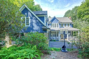 A two-story house with a prominent gable roof and a covered porch. - Boone Home w/ Fire Pit - Near App Ski & Sugar Mtn! (Boone)