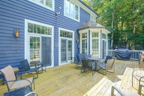 A blue house with a deck, outdoor seating, and a covered grill area. - Boone Home w/ Fire Pit - Near App Ski & Sugar Mtn! (Boone)