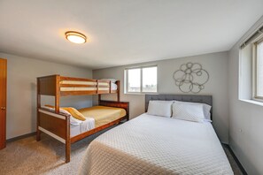 A bedroom with a bunk bed, a large bed, and a window with a view. - Family-friendly Yakima Escape w/ Yard & Pool! (Yakima)