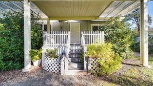 A covered porch with a white fence, steps leading to a door, and potted plants. - Mtn Gate Guest House ~ 6 Mi to Shasta Lake! (Redding)
