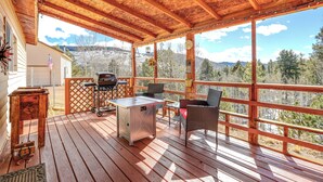A wooden deck with a grill, chairs, and a table. - Colorado Vacation Rental w/ Deck & Mtn Views (Cripple Creek)