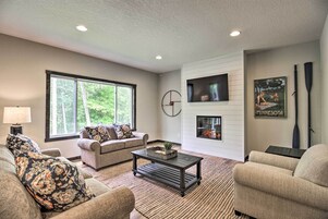 A living room with a sofa, coffee table, and a fireplace.