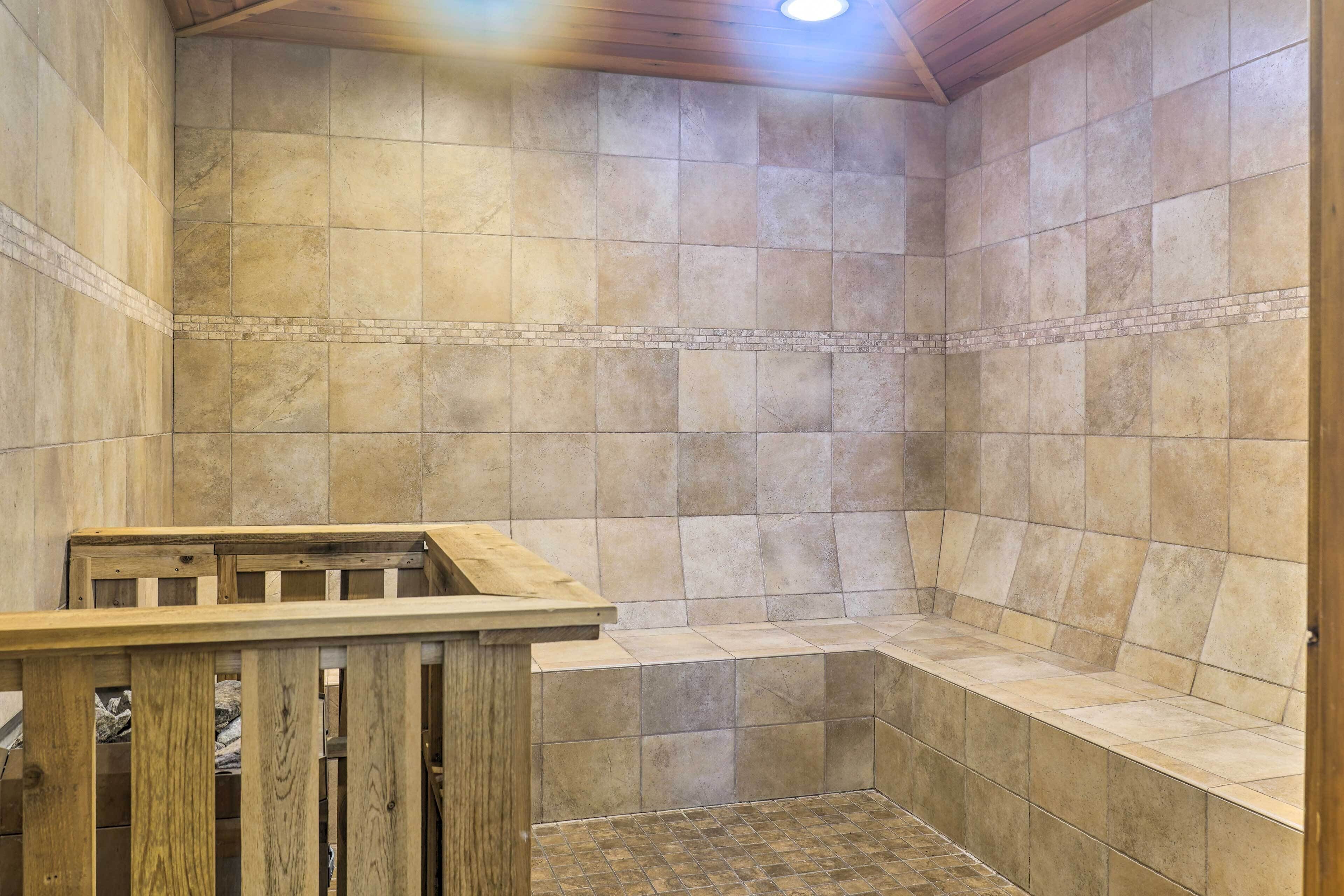 A shower area with tiled walls and a wooden bench.