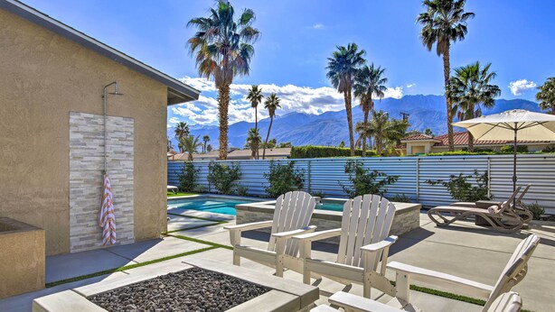 A patio with Adirondack chairs, a fire pit, and a pool. - Palm Springs Pad w/ Outdoor Kitchen + Views! (Palm Springs)
