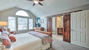 A bedroom with a bed, a ceiling fan, a TV, and a sliding door. - 'wasatch Basecamp' w/ Hot Tub: Hike & Explore! (Salt Lake City)