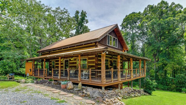 A wooden cabin with a large porch, surrounded by a natural landscape. - Stunning Creekside Cosby Cabin w/ Deck + Fire Pit! (Cosby)