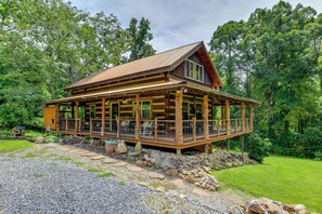 A wooden cabin with a large porch, surrounded by a natural landscape. - Stunning Creekside Cosby Cabin w/ Deck + Fire Pit! (Cosby)