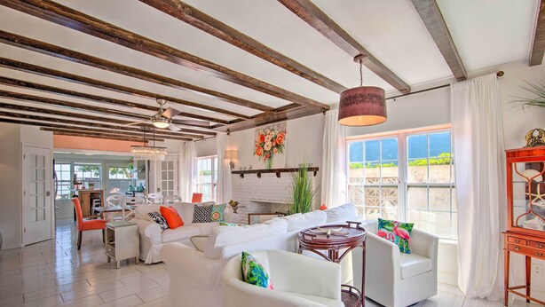 A spacious living room with white sofas, a wooden ceiling, and a large window with a view. - Waterfront Port Isabel Family Home w/ Pool & Pier! (Port Isabel)
