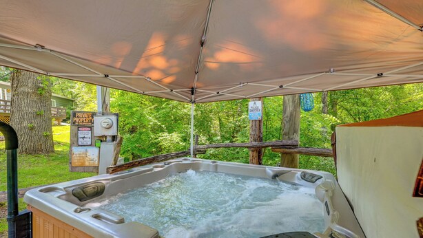 Un jacuzzi installé sous une pergola, avec un panneau indiquant « PROPRIÉTÉ PRIVÉE », le tout entouré d’une végétation luxuriante.