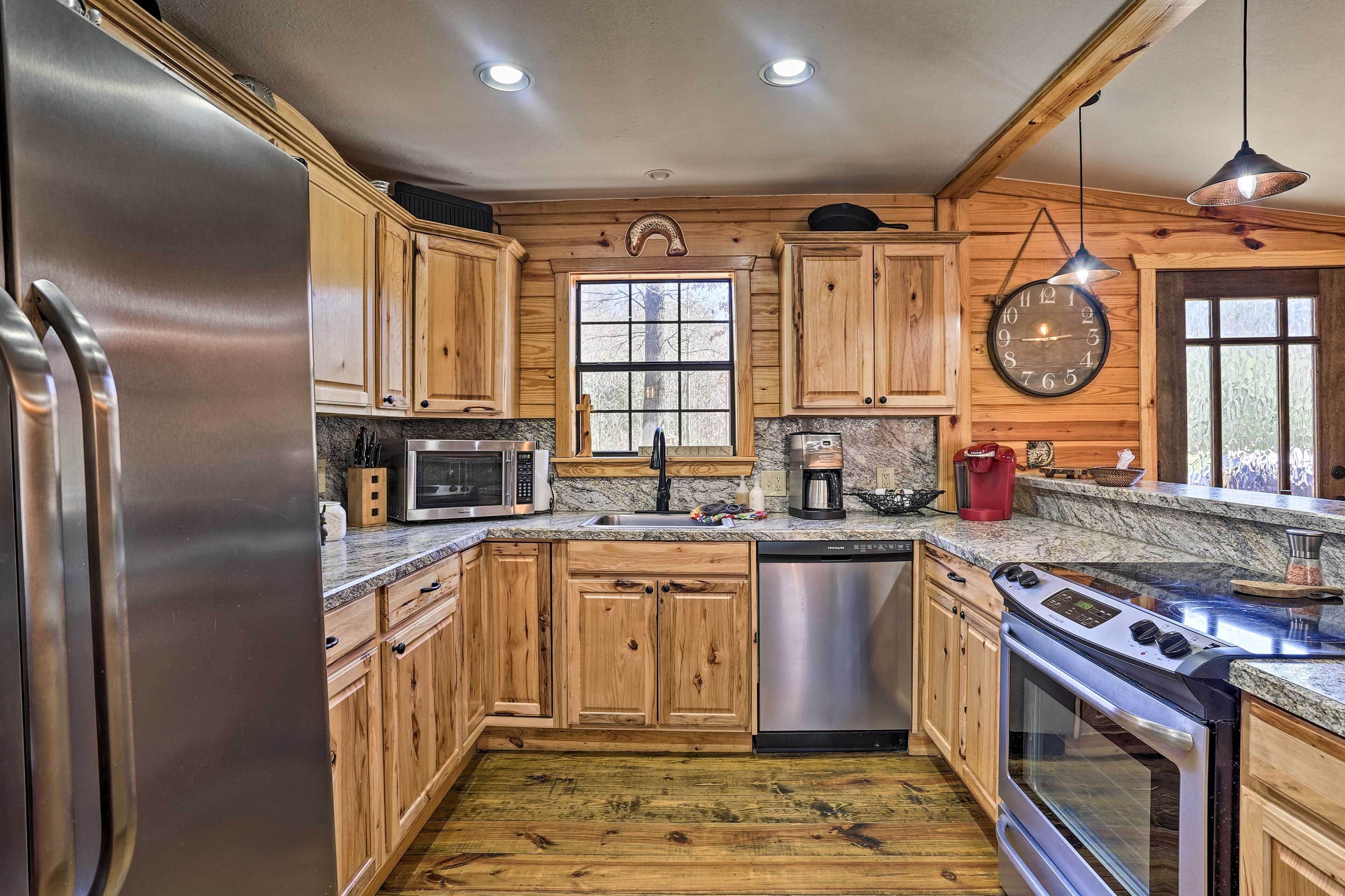 A modern kitchen with wooden cabinets, stainless steel appliances, and a large window.