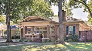 A brick house with a front porch, a chimney, and a wooden fence. - Walk to Midwestern State: Wichita Falls Cottage! (Wichita Falls)