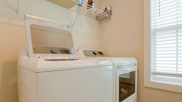 A front-loading washer and dryer in a laundry room with a window on the right. - 3 Decks & Beach Access: Hilton Head Home (Hilton Head Island)