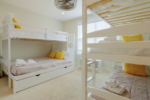 A bunk bed room with a ceiling fan, a window with blinds, and a 'my happy place' pillow. - 3 Decks & Beach Access: Hilton Head Home (Hilton Head Island)