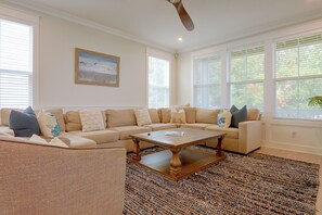 A spacious living room with a sectional sofa, a coffee table, and a ceiling fan. - 3 Decks & Beach Access: Hilton Head Home (Hilton Head Island)