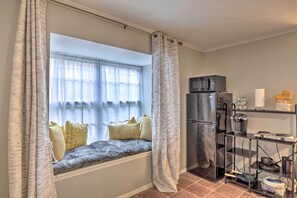A kitchen with a built-in window seat, a refrigerator, and a metal shelf unit. - ~ 10 Mi to Downtown: Quiet Dallas Studio (Dallas)