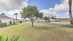 A residential area with houses, a tree, and a well-maintained lawn. - Laguna Vista Home w/ Resort Perks Near Beach! (Port Isabel)