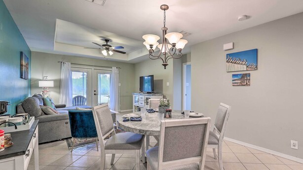 A modern kitchen with a dining area, a ceiling fan, and a chandelier. - Laguna Vista Home w/ Resort Perks Near Beach! (Port Isabel)
