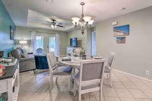 A modern kitchen with a dining area, a ceiling fan, and a chandelier. - Laguna Vista Home w/ Resort Perks Near Beach! (Port Isabel)