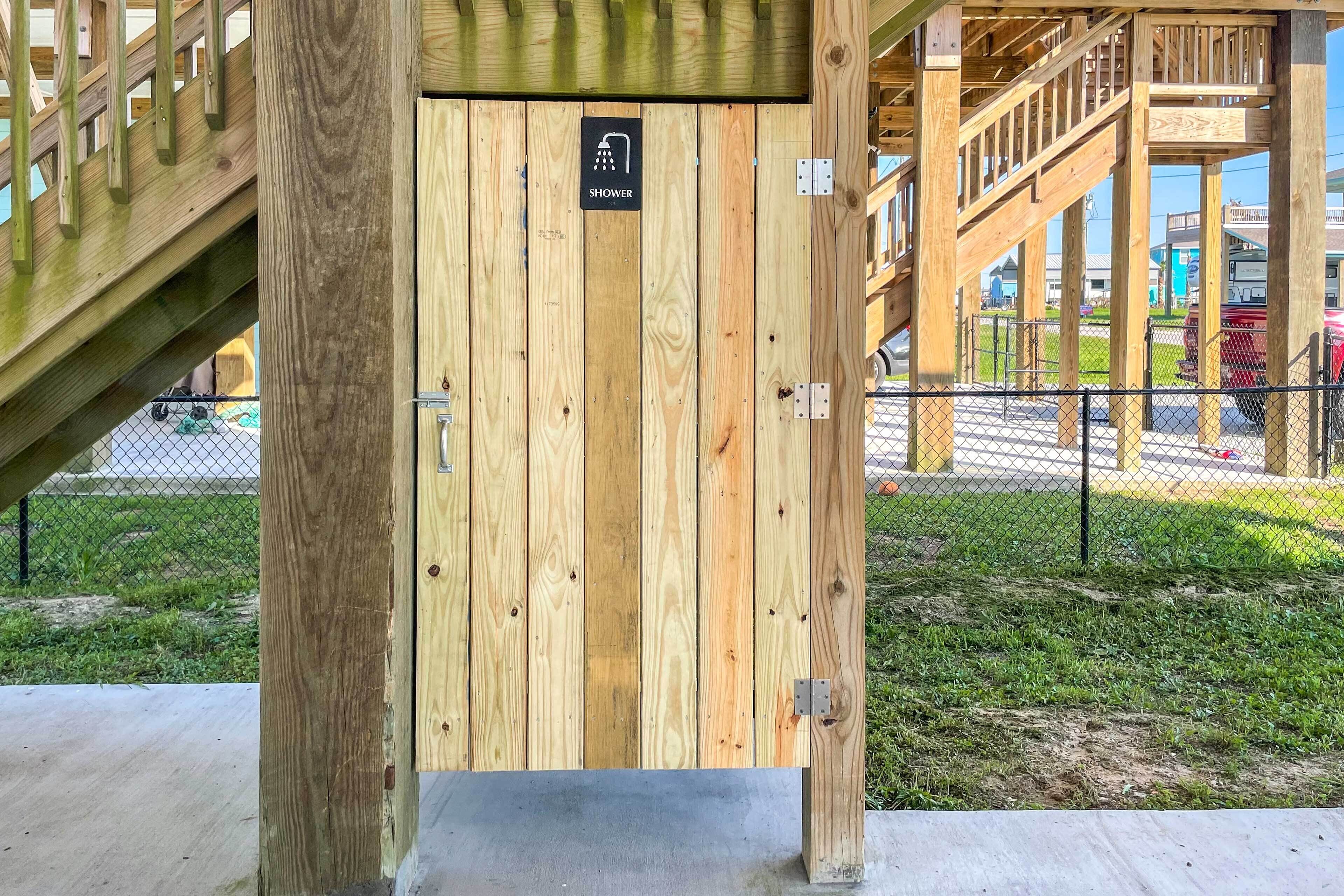 A wooden structure with a sign indicating a shower.