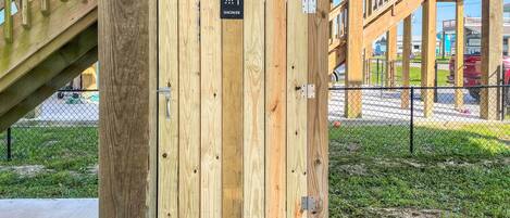 A wooden structure with a sign indicating a shower.