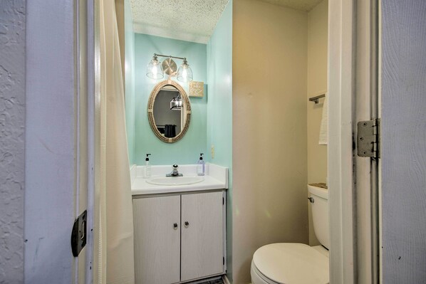 A bathroom with a white sink, a mirror with a gold frame, and a toilet. - Osage Beach Home w/ Private Hot Tub: Near Lake! (Osage Beach)