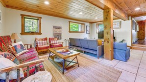 A cozy living room with a sofa, chairs, and a coffee table. - Saranac Lake Cabin w/ Deck: Pets Welcome! (Saranac Lake)