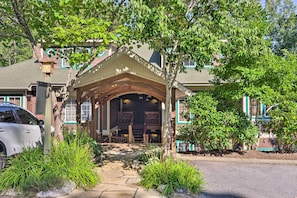 A covered entrance to a building with a stone pathway leading to a wooden porch.