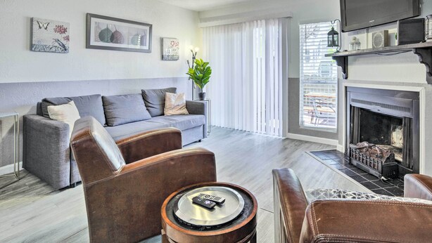 A living room with a sofa, armchairs, a fireplace, and a television. - Pet-friendly Bryan Escape ~ 2 Mi to Texas A & M (Bryan)