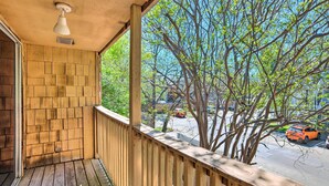 A wooden balcony with a view of a tree-lined street and parked cars. - Pet-friendly Bryan Escape ~ 2 Mi to Texas A & M (Bryan)