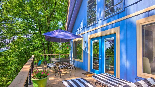 A blue house with a deck, outdoor furniture, and a large umbrella. - Mtn-view Gem in Lake Lure w/ Game Room & Fire Pit (Lake Lure)