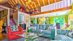 A spacious living area with a staircase, a sofa set, and a coffee table. - Mtn-view Gem in Lake Lure w/ Game Room & Fire Pit (Lake Lure)