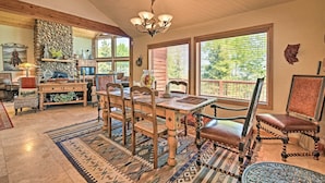 A rustic dining area with a wooden table, chairs, and a chandelier. - Angel Fire Mountain-view Retreat w/ Private Deck! (Angel Fire)