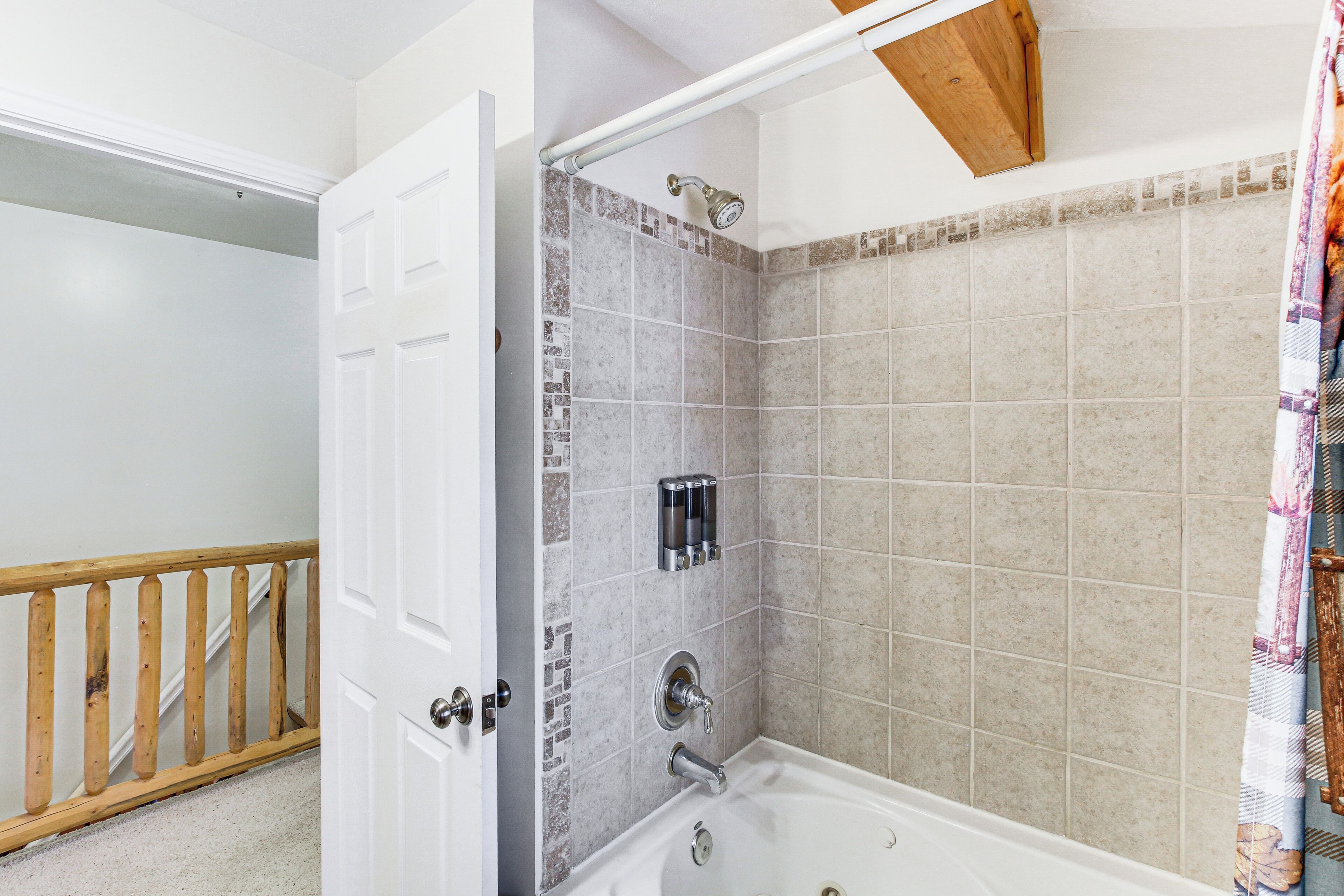 A bathroom with a shower, a bathtub, and a toilet.
