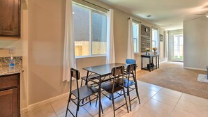 A spacious dining area with a table and chairs, large windows with curtains, and a view of the outside. - 4 Mi to City Center: Family-friendly Retreat! (Merced)