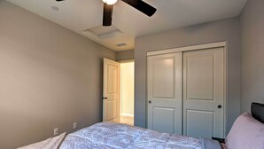 A bedroom with a bed, a ceiling fan, and a door leading to another room. - 4 Mi to City Center: Family-friendly Retreat! (Merced)