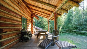 A wooden deck with a table and chairs, surrounded by a forested area. - Cozy Easton Cabin w/ Wenatchee Nat'l Forest Views! (Easton)