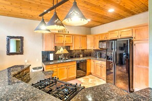 A kitchen with granite countertops, wooden cabinets, stainless steel appliances, and pendant lighting. - Pagosa Springs Mountain Haven: 5 Mi to Hot Springs (Pagosa Springs)